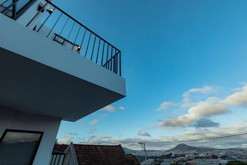 a balcony of a building with a view of a city at La Villa Da Lat in Khu Chi Lăng