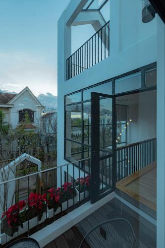 a view from the balcony of a house with red flowers at La Villa Da Lat in Khu Chi Lăng