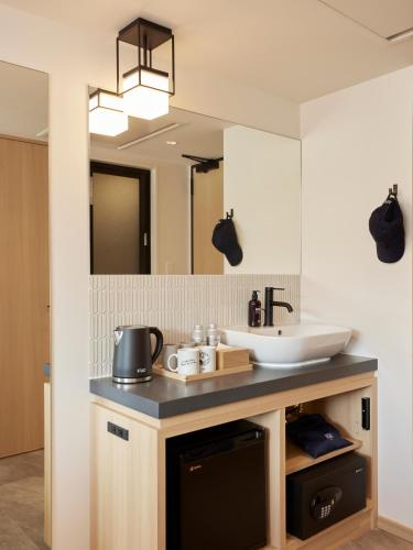 a bathroom with a sink and a mirror at ASAI Kyoto Shijo in Kyoto