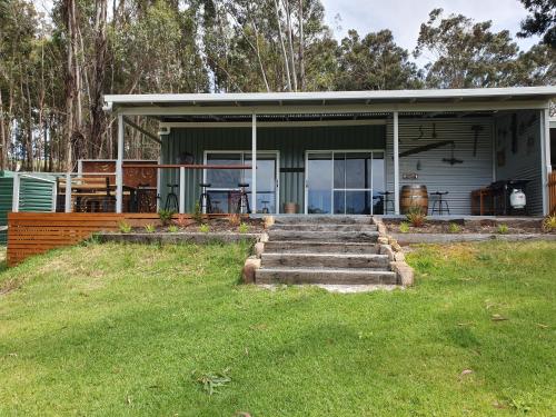 a house with steps in front of a yard at Preston Valley Shed Stay in Lowden