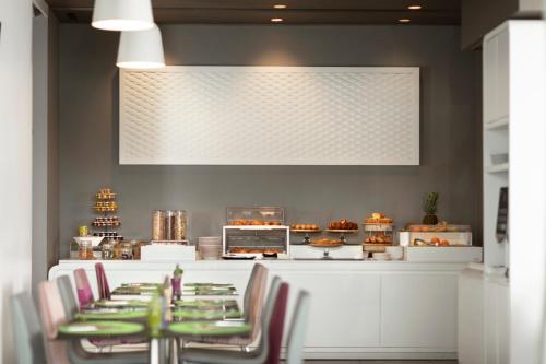 a restaurant with chairs and a counter with cakes at 8Piuhotel in Lecce