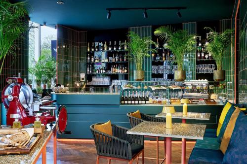 a restaurant with two tables and a bar at Le Méridien Vienna in Vienna