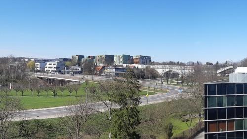 a view of a city with a building and a highway at Mhost Bronowice in Kraków