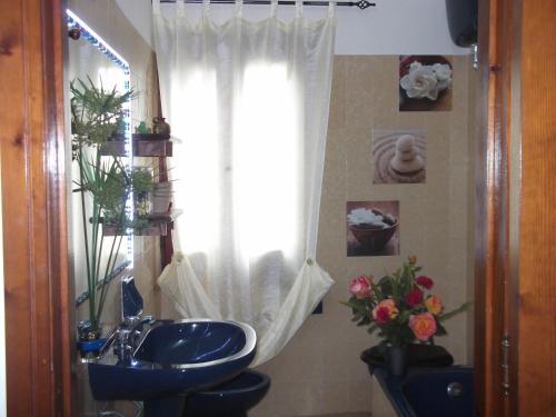 Un baño con lavabo y ventana. en Helianthus rooms, en Pula