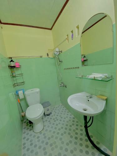 a bathroom with a sink and a toilet and a mirror at Rose's House in Khu Chi Lăng