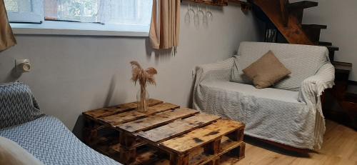 a living room with two chairs and a coffee table at Welcome Guests in Tbilisi City