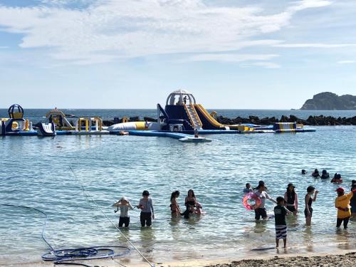 a group of people in the water at a water park at Doublerainbow Resort Katsuura in Katsuura