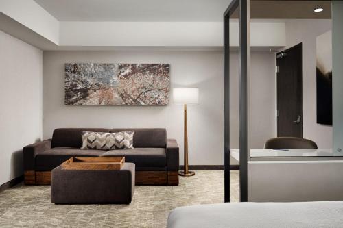a living room with a couch and a table at SpringHill Suites by Marriott Milpitas Silicon Valley in Milpitas
