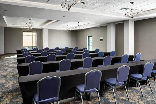 a conference room with chairs and a long table in a room at SpringHill Suites by Marriott Milpitas Silicon Valley in Milpitas