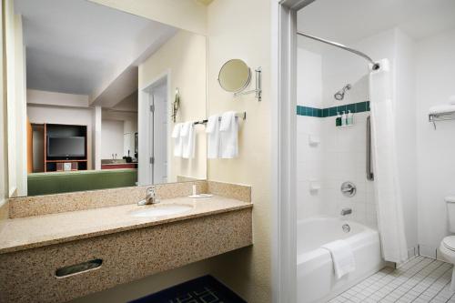 a bathroom with a sink and a tub and a toilet at Fairfield Inn & Suites by Marriott San Francisco San Carlos in San Carlos