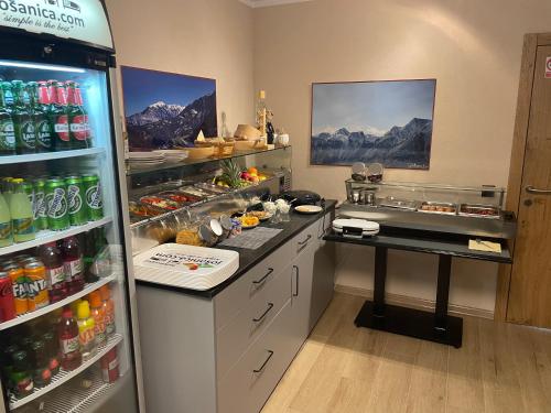 a kitchen with a refrigerator filled with lots of drinks at Josanica Bed&Breakfast in Konjic