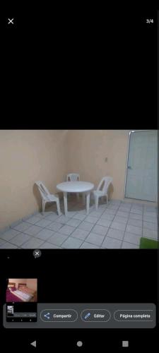 a tv screen with a table and chairs in a room at Posada en celaya in Celaya