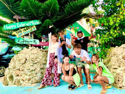 a group of people posing for a picture at a resort at Happy Island Miyako in Miyako Island