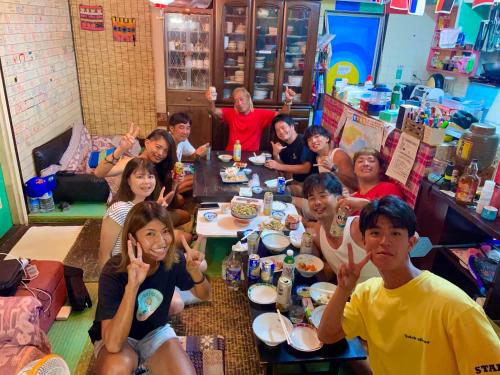 a group of people sitting around a table eating at Happy Island Miyako in Miyako Island