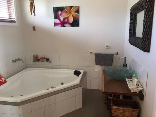 a bathroom with a large tub and a sink at Surfside Escape in Surf Beach