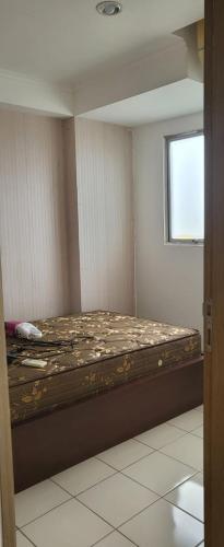 a bed in a room with a window at Icon gading in Jakarta