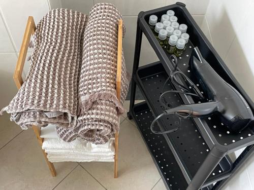 a blanket sitting on a chair next to a sink at 60sqm "Piece of heaven" in Munich's south in Munich