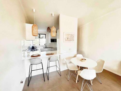 a kitchen with a white table and chairs in a room at 2 Minute walk from the Waters Edge in Perth