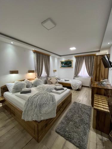 a large bedroom with two beds and a couch at Rustic Inn River in Plitvička Jezera