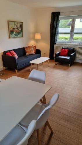 a living room with a couch and two chairs at Mecklenburgische Seenplatte - FH mit optionalem Steg und Ruderboot in Großzerlang