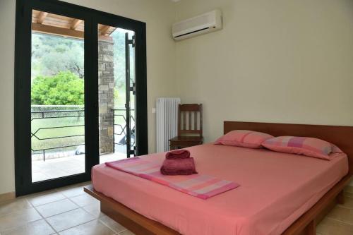 a bedroom with a large bed with pink sheets at Sens de Dieu - Private luxury in Diakopto