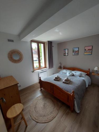 a bedroom with a large bed and a wooden floor at L' Epi de Blé in Lacres