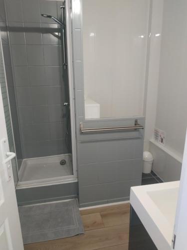 a bathroom with a shower with a glass door at Charmant logement à 2 pas de la plage in Le Portel