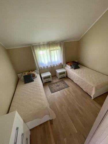 an overhead view of a bedroom with two beds and a window at Sea Side house (70m2) Lejas Ziediņi in Plieņciems