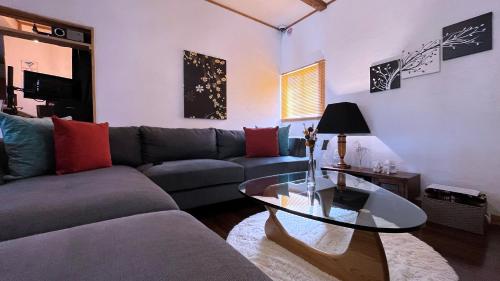a living room with a couch and a glass table at Sanga Nikko in Nikko