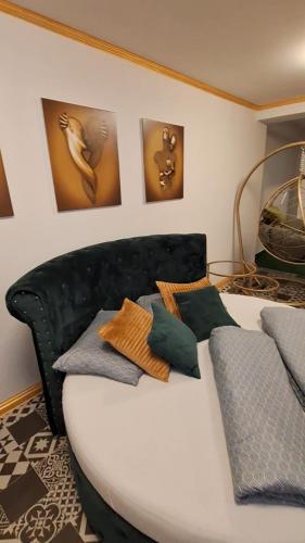 a bed with pillows on it in a room at Guest House Villa Lord in Novi Sad