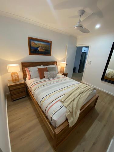a bedroom with a large bed with two night stands at Preston Valley Country Cabin in Lowden