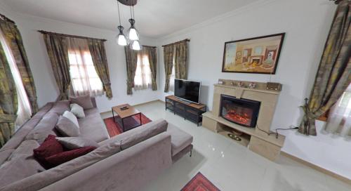 a living room with a couch and a fireplace at Castello Marmaris Holiday Home in Marmaris