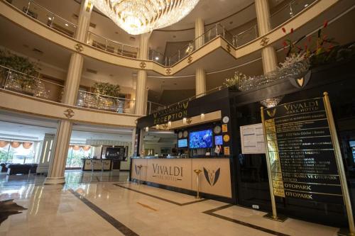 a lobby of a building with a sign in the middle at Vivaldi Park Hotel in Ankara