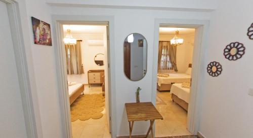 a hallway leading to a living room with a mirror at Castello Marmaris Holiday Home in Marmaris
