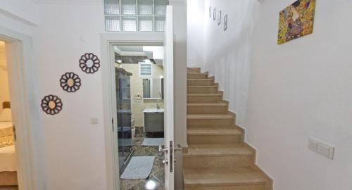 a staircase in a home with white walls at Castello Marmaris Holiday Home in Marmaris