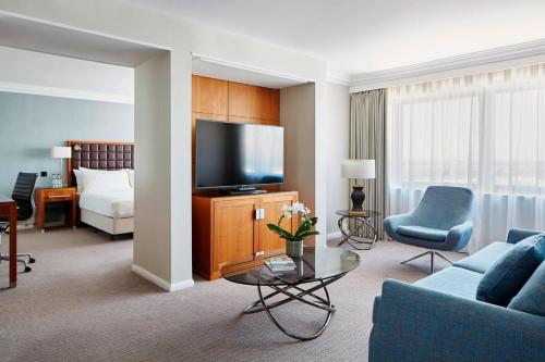 a living room with a couch and a tv at Portsmouth Marriott Hotel in Portsmouth