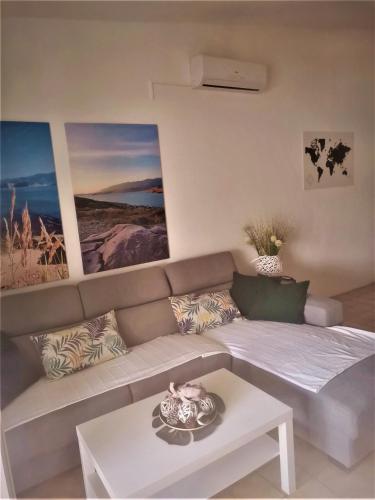 a living room with a couch and a table at Apartments Alma in Pag