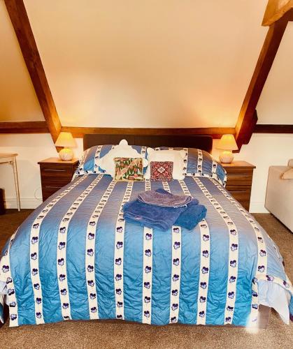 a blue and white bed in a room at Grange stables in North Cadbury