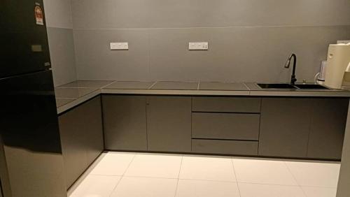 a kitchen with a sink and a counter top at Villa 8812 极简风民宿 舒适现代风 in Kampong Sungai Udang