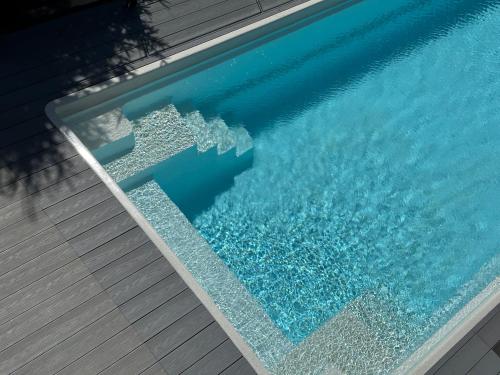 a swimming pool with water in it at be be Chalet - premium jacuzi & private pool in Bukovel