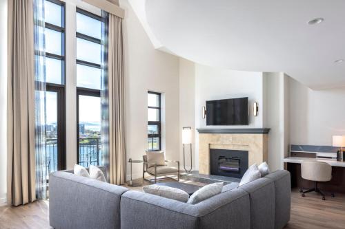 a living room with a couch and a fireplace at Delta Hotels by Marriott Victoria Ocean Pointe Resort in Victoria