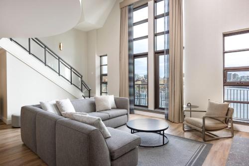 a living room with a couch and a table at Delta Hotels by Marriott Victoria Ocean Pointe Resort in Victoria