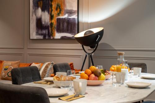 a table with a bowl of fruit on it at My Opéra in Paris