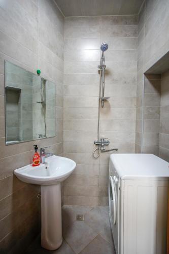 a bathroom with a sink and a shower and a toilet at city point in Kutaisi
