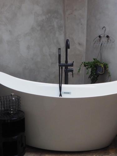 a bath tub with a faucet in a bathroom at Moulin Bas, Prés de la Rivière in Carnac-Rouffiac