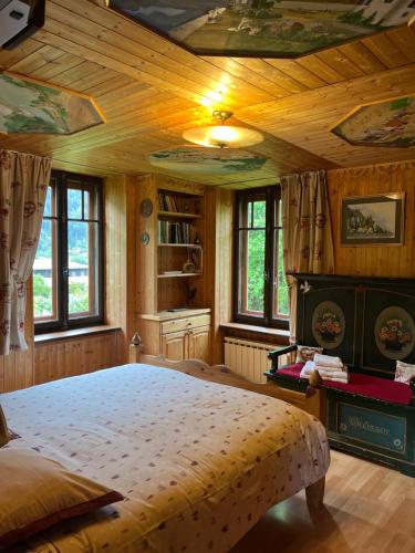 a bedroom with a large bed with a wooden ceiling at La Crèmerie du Vernet in Chamonix