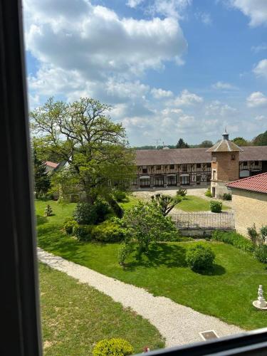 a view of a building from a window at Château de Crespy & Suites in Crespy-le-Neuf