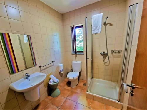 a bathroom with a sink and a toilet and a shower at HI Geres - Pousada de Juventude do Gerês in Geres