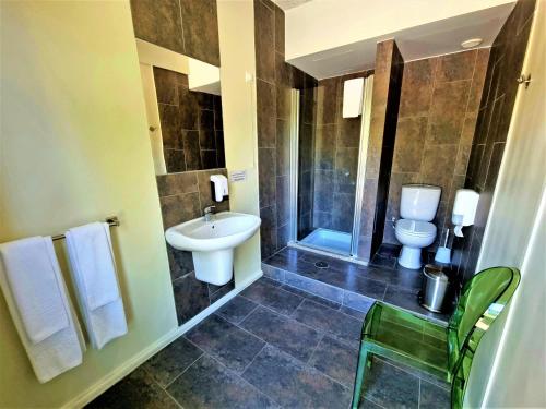 a bathroom with a sink and a shower and a toilet at HI Geres - Pousada de Juventude do Gerês in Geres