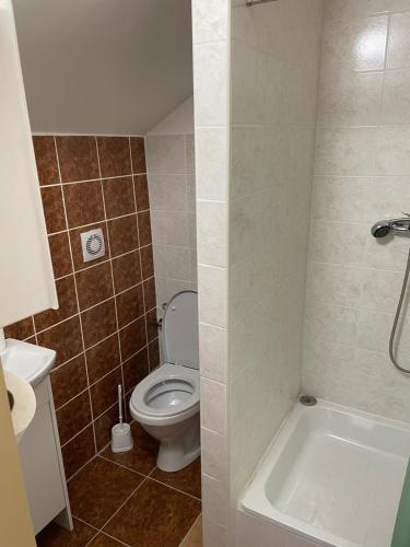 a bathroom with a toilet and a sink and a tub at Izba MARTINA v Penzione pod Smrekom in Martin